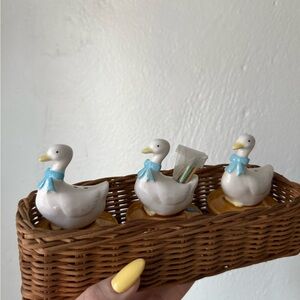 Duck Figurines with Blue Bows in Wicker Basket